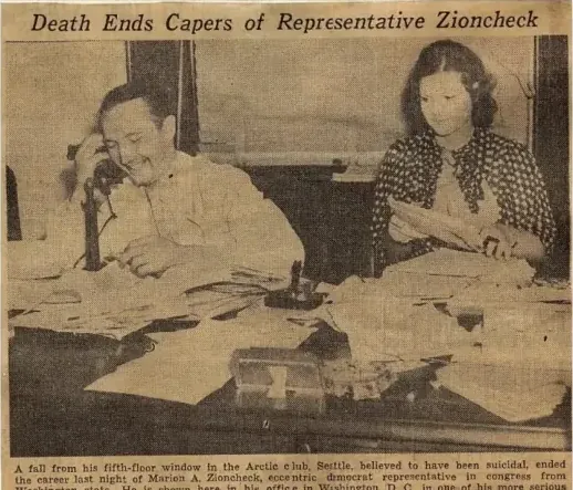 Newspaper photograph of Marion Zioncheck seated at a desk with a woman standing beside him